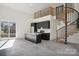 Open-concept space with black kitchen cabinets, modern island, spiral staircase, and a sliding door at 122 Laura Rd # B, Mooresville, NC 28117