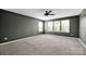 Spacious bedroom with a ceiling fan and lots of natural light from multiple windows at 13408 Portside Ln, Lancaster, SC 29720