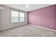 Cozy bedroom with soft carpet, a window with blinds, and painted accent wall at 13408 Portside Ln, Lancaster, SC 29720