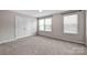 Bright bedroom with neutral carpet, natural light from the double windows, and a double closet for storage at 13408 Portside Ln, Lancaster, SC 29720