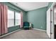 Bedroom with ample natural light from the windows, neutral carpet and a reading chair at 13408 Portside Ln, Lancaster, SC 29720