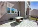 Outdoor deck with a table set, overlooking the home's exterior, and perfect for relaxation and entertaining at 13408 Portside Ln, Lancaster, SC 29720