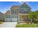 Charming two-story home with a two car garage, beautiful landscaping, and welcoming front porch at 13408 Portside Ln, Lancaster, SC 29720