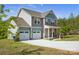 Two-story home featuring a two-car garage, neutral siding, and well-maintained landscaping at 13408 Portside Ln, Lancaster, SC 29720