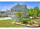 Two-story home featuring manicured landscaping and garden beds at 13408 Portside Ln, Lancaster, SC 29720