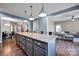 Modern kitchen features granite countertops, large island, and easy access to the living room at 13408 Portside Ln, Lancaster, SC 29720