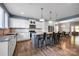 Spacious kitchen features an island with bar seating, stainless appliances, and white cabinetry at 13408 Portside Ln, Lancaster, SC 29720