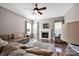 Cozy living room boasts a fireplace, large windows, and comfortable seating at 13408 Portside Ln, Lancaster, SC 29720