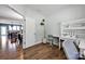 Home office featuring hardwood floors, built-in desk, and view into dining room at 13408 Portside Ln, Lancaster, SC 29720