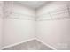 Walk-in closet featuring wire shelving and neutral carpet at 13408 Portside Ln, Lancaster, SC 29720