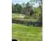 Spacious backyard featuring a fire pit area and views of horses grazing behind a white fence at 1418 Lonan Dr, Waxhaw, NC 28173