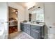 Bathroom with double sink vanity, marble countertops, and large mirror at 1418 Lonan Dr, Waxhaw, NC 28173