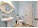 Powder blue bathroom featuring a pedestal sink, updated fixtures, and a tile floor at 1418 Lonan Dr, Waxhaw, NC 28173
