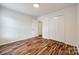 Bedroom with hardwood floors, closet and access to additional rooms at 1418 Lonan Dr, Waxhaw, NC 28173