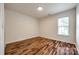 Neutral bedroom with hardwood floors and natural light from window at 1418 Lonan Dr, Waxhaw, NC 28173