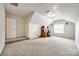 Bonus room with a dormer window, neutral carpet, and a built-in desk for a comfortable workspace at 1418 Lonan Dr, Waxhaw, NC 28173
