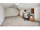 Bonus room featuring neutral carpet, dormer window, and a built-in desk for a functional workspace at 1418 Lonan Dr, Waxhaw, NC 28173