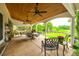 A charming covered patio with outdoor seating, ceiling fans, and a view of the lush backyard at 1418 Lonan Dr, Waxhaw, NC 28173