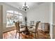 Bright dining room with hardwood floors, chandelier, and a large window at 1418 Lonan Dr, Waxhaw, NC 28173