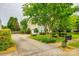 Long driveway leading to a well-maintained home with manicured landscaping at 1418 Lonan Dr, Waxhaw, NC 28173