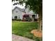 Charming two-story home with stone accents, mature trees, and well-maintained landscaping enhancing the curb appeal at 1418 Lonan Dr, Waxhaw, NC 28173