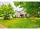 Charming home with well-manicured front lawn and garden, complemented by mature trees at 1418 Lonan Dr, Waxhaw, NC 28173