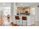 Kitchen area showcasing wood cabinets, marble countertops, and a bar-style seating area at 1418 Lonan Dr, Waxhaw, NC 28173