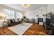 Bright living room with a fireplace, hardwood floors, and cozy seating at 1418 Lonan Dr, Waxhaw, NC 28173