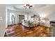 Main bedroom featuring tray ceilings, hardwood flooring, and ornate furniture at 1418 Lonan Dr, Waxhaw, NC 28173