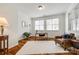 Bright office area with hardwood flooring and a large white rug at 1418 Lonan Dr, Waxhaw, NC 28173