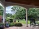 Covered patio featuring elegant columns, garden views, and comfortable seating, perfect for outdoor relaxation at 1418 Lonan Dr, Waxhaw, NC 28173