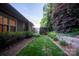 Manicured backyard with privacy landscaping, and a lush green lawn at 142 Aztec Cir, Mooresville, NC 28117