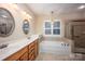 Bright bathroom features double sinks, soaking tub, and separate glass-door shower at 142 Aztec Cir, Mooresville, NC 28117