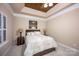 Comfortable bedroom featuring tray ceilings, neutral walls and plush carpet at 142 Aztec Cir, Mooresville, NC 28117