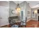 Dining area featuring elegant lighting, a glass table, and views of the outside at 142 Aztec Cir, Mooresville, NC 28117