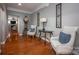 Foyer showcasing hardwood floors, elegant chairs, and decorative wall art at 142 Aztec Cir, Mooresville, NC 28117