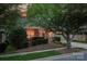 Charming exterior with well-manicured landscaping, inviting porch, and attached two-car garage at 142 Aztec Cir, Mooresville, NC 28117
