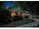 Charming home featuring a beautifully landscaped front yard with mature trees and inviting curb appeal at night at 142 Aztec Cir, Mooresville, NC 28117