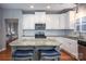Bright kitchen with white cabinetry, stainless steel appliances, and a granite island with seating at 142 Aztec Cir, Mooresville, NC 28117