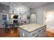 Open kitchen featuring granite countertops and hardwood floors, flowing into the dining and living areas at 142 Aztec Cir, Mooresville, NC 28117