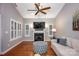 Bright living room featuring a fireplace, vaulted ceiling, and large windows with plantation shutters at 142 Aztec Cir, Mooresville, NC 28117