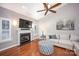 Comfortable living room with a fireplace, ceiling fan, and natural light at 142 Aztec Cir, Mooresville, NC 28117