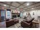 Inviting living room featuring a stone fireplace, coffered ceilings, and comfortable seating for relaxation at 142 Aztec Cir, Mooresville, NC 28117