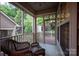 Cozy screened porch with wicker furniture and views of the private backyard at 142 Aztec Cir, Mooresville, NC 28117