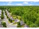 Aerial view showcasing a tree-lined neighborhood with well-maintained homes, lawns and wooded areas at 1457 Mandy Place Ct, Charlotte, NC 28216