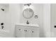 Modern bathroom featuring sleek black fixtures, a round mirror, and a vanity with storage at 1457 Mandy Place Ct, Charlotte, NC 28216