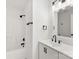 Modern bathroom features sleek white vanity, shower and tub, and black fixtures at 1457 Mandy Place Ct, Charlotte, NC 28216
