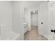 Fresh, clean bathroom with light wood floors, vanity storage, and bright natural light at 1457 Mandy Place Ct, Charlotte, NC 28216