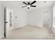 This carpeted bedroom features a ceiling fan, ample space, and access to an ensuite bathroom and walk-in closet at 1457 Mandy Place Ct, Charlotte, NC 28216