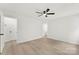 Bedroom featuring wood-look floors, ceiling fan and ensuite bathroom at 1457 Mandy Place Ct, Charlotte, NC 28216